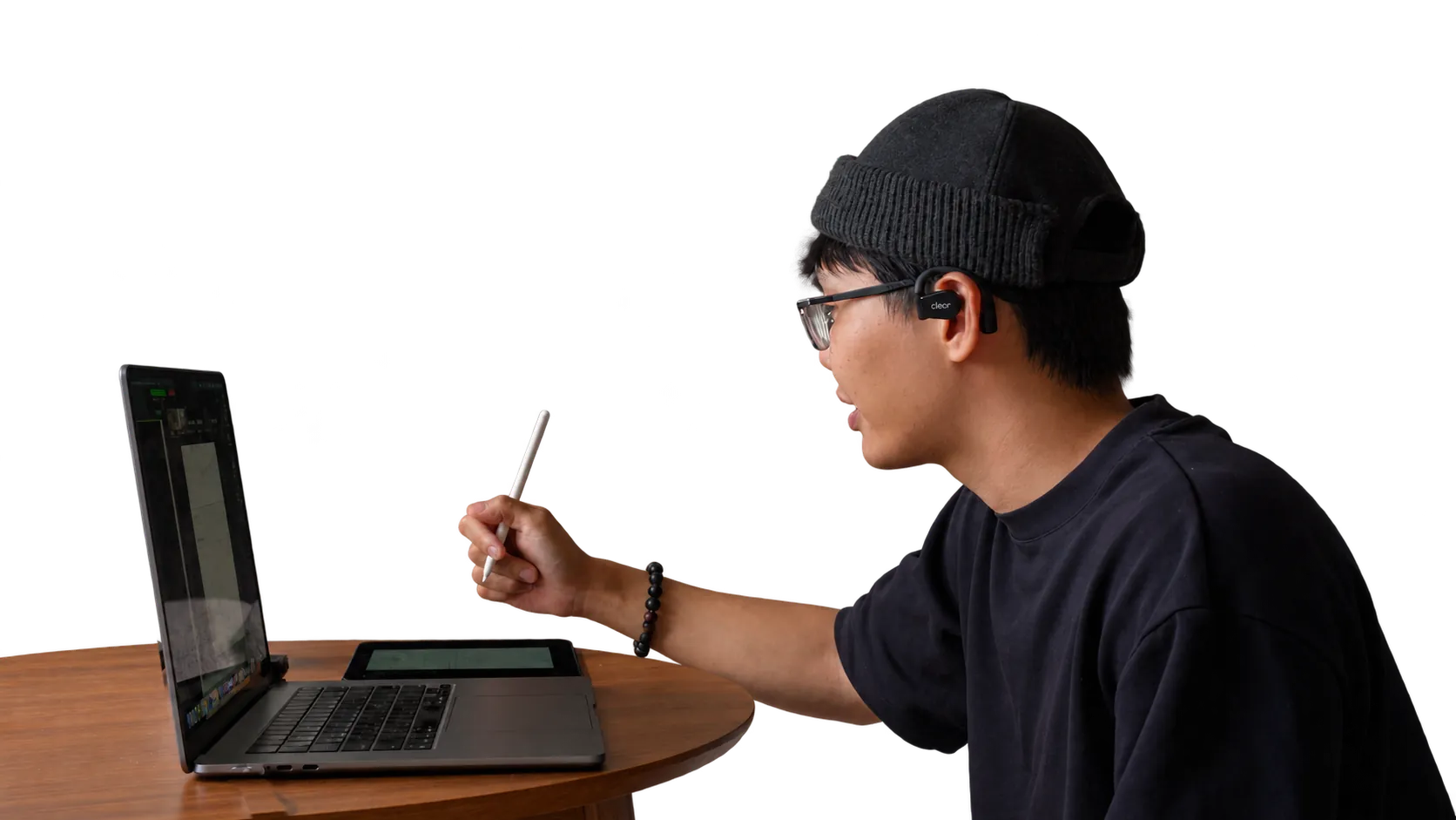 David working with a MacBook, iPad and Apple Pencil during a client session